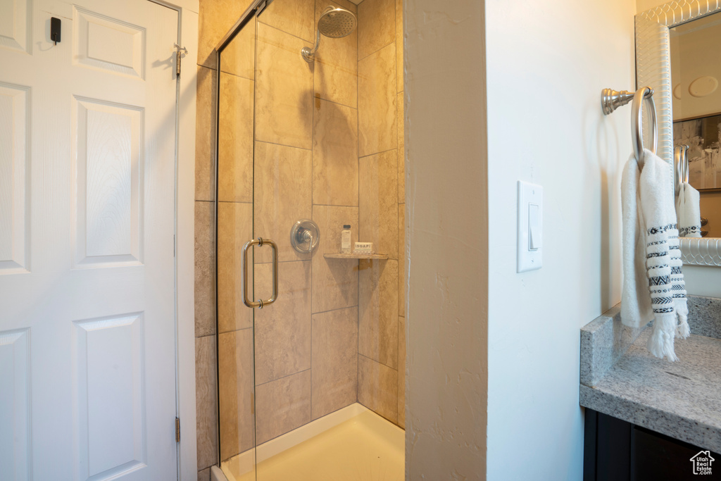 Full bath with vanity and a shower stall