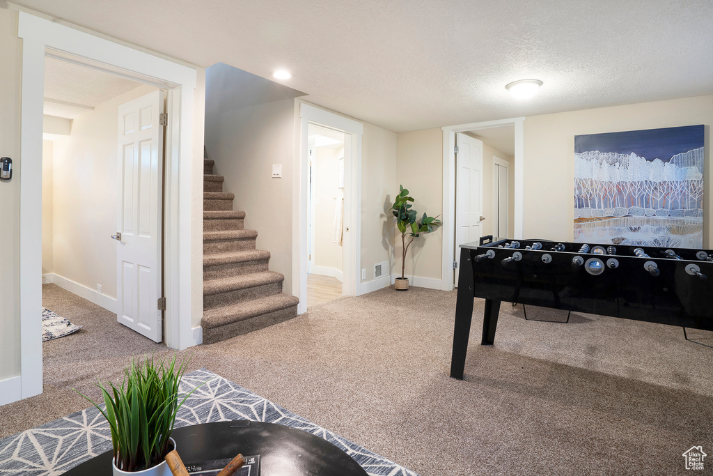 Game room featuring baseboards, visible vents, and carpet