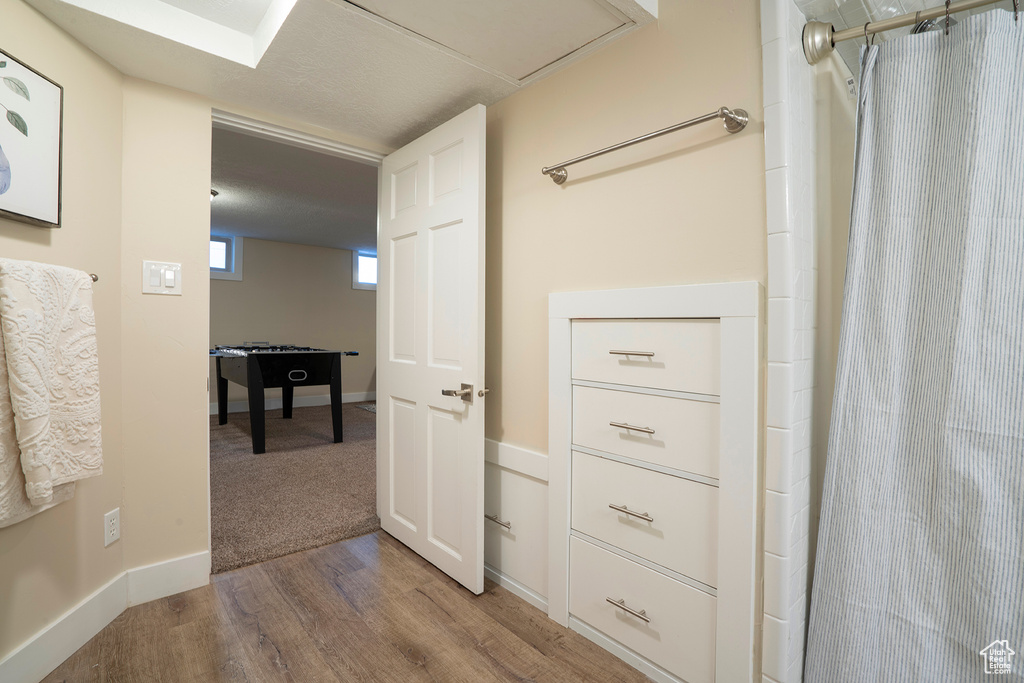 Hallway with baseboards and wood finished floors