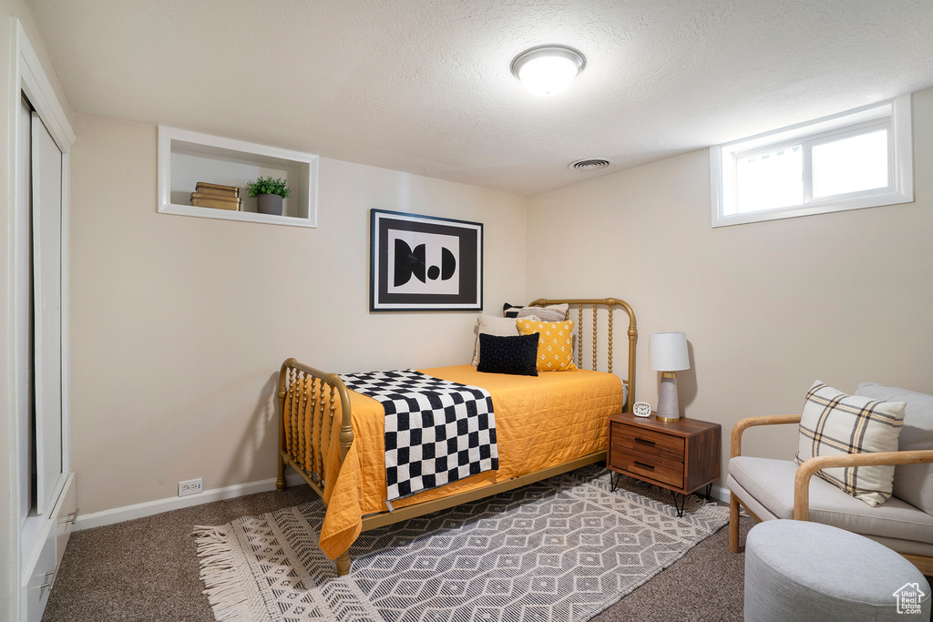 Carpeted bedroom featuring baseboards
