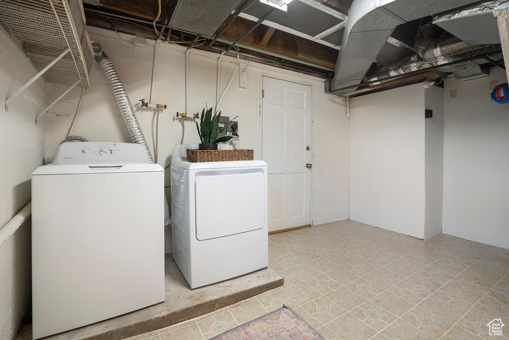 Washroom featuring laundry area and washing machine and clothes dryer