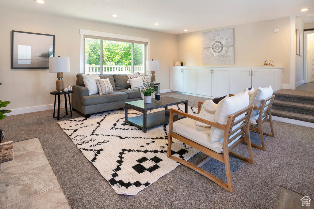 Living area featuring recessed lighting, baseboards, and light colored carpet