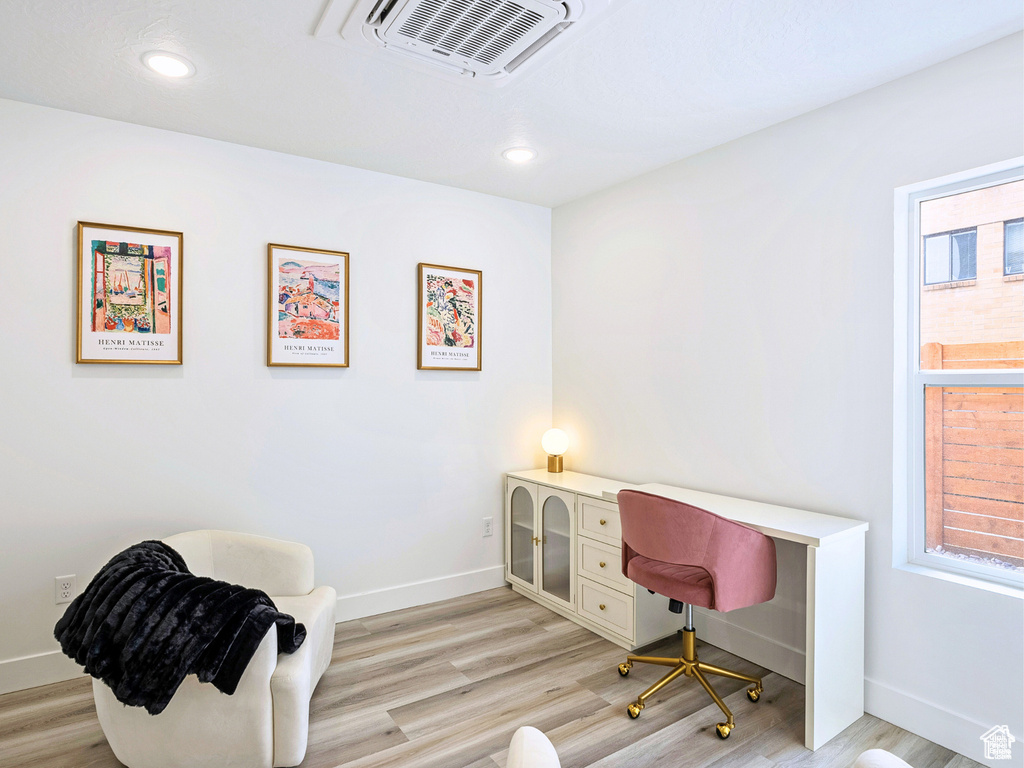 Home office with recessed lighting, baseboards, light wood finished floors, and visible vents