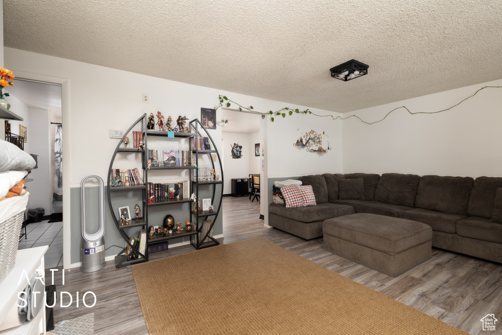 Living room with a textured ceiling and wood finished floors