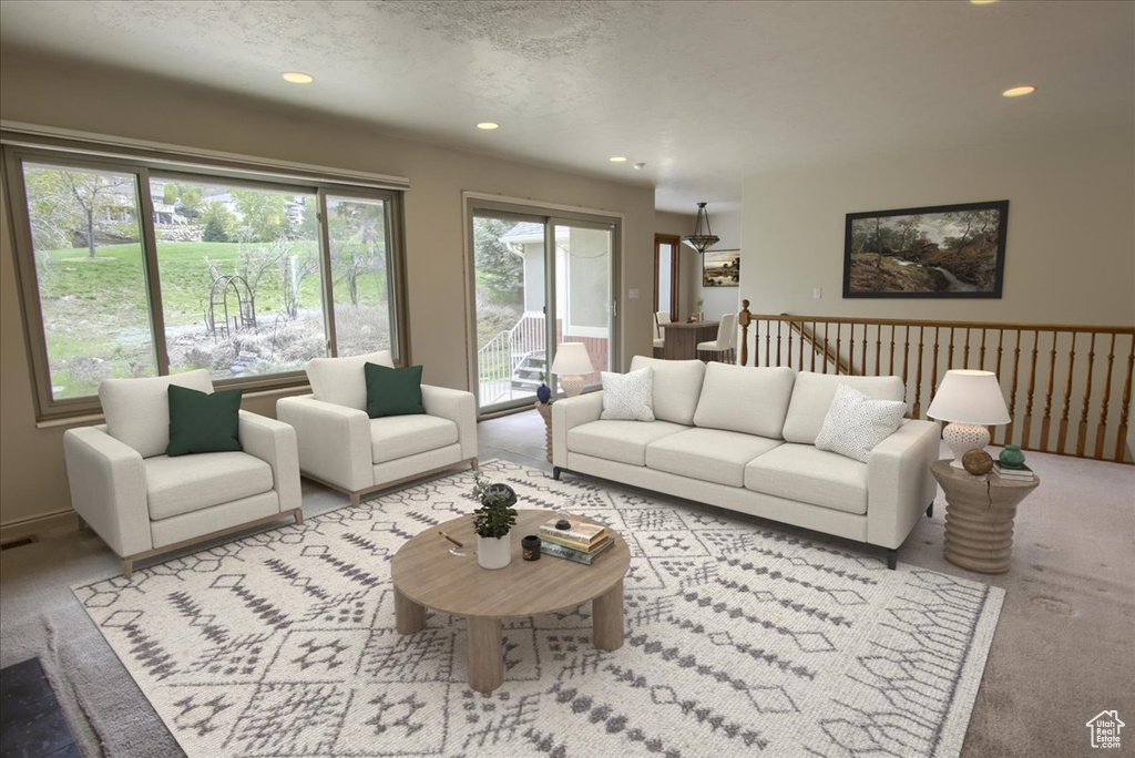 Living area with carpet flooring, recessed lighting, and visible vents