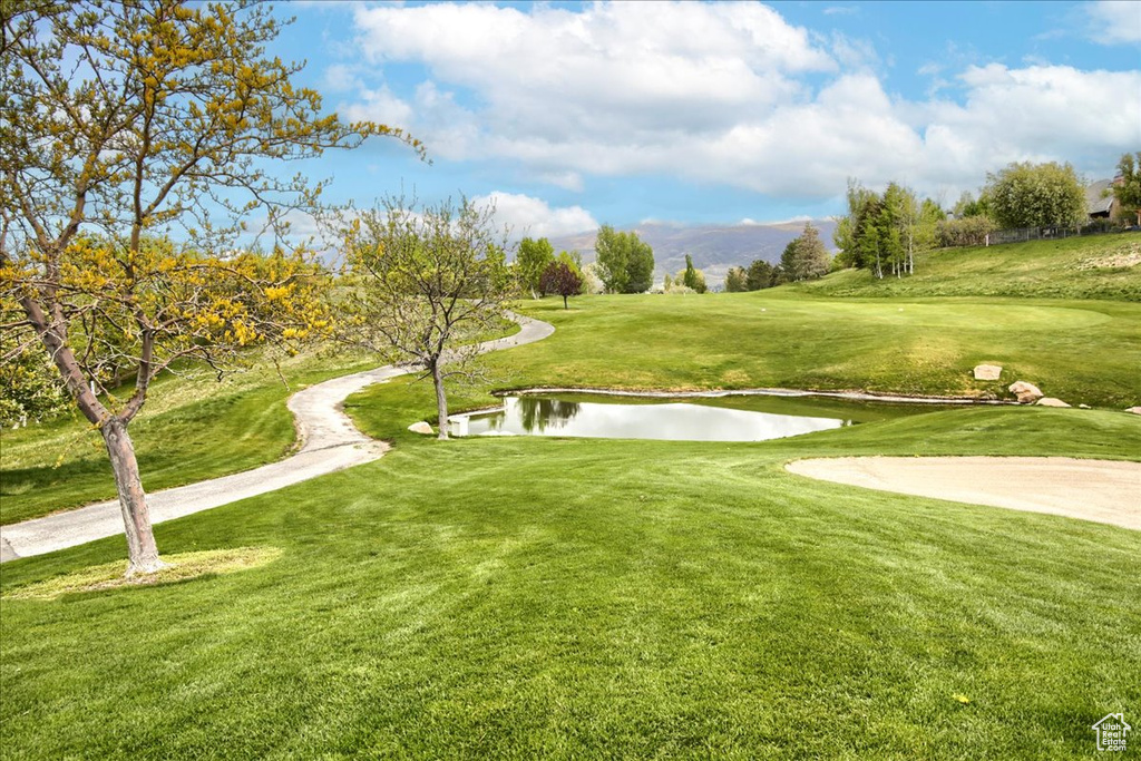 View of property\\\'s community with a water view, golf course view, and a yard