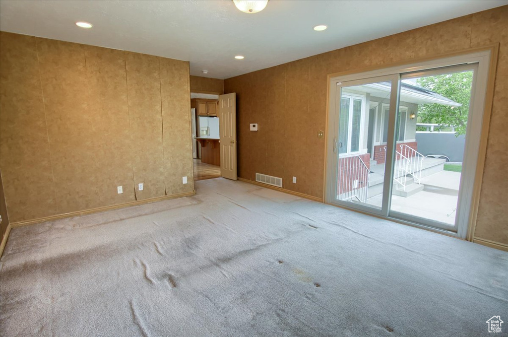 Carpeted spare room with recessed lighting, baseboards, and visible vents
