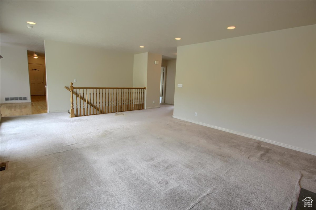 Carpeted empty room with recessed lighting, baseboards, and visible vents
