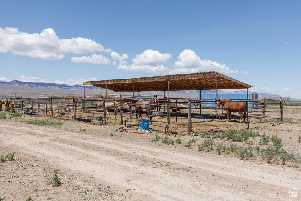 View of outbuilding featuring an outdoor structure, an exterior structure, a mountain view, and a rural view