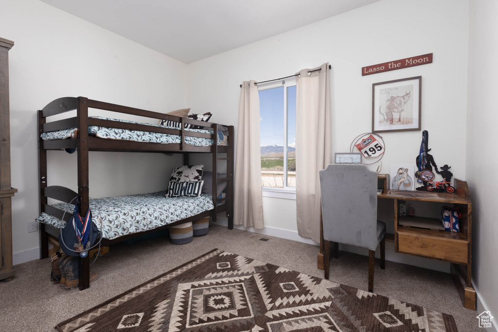 Bedroom featuring carpet floors and baseboards