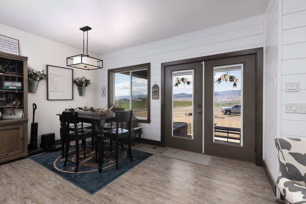 Dining area with french doors and light wood finished floors