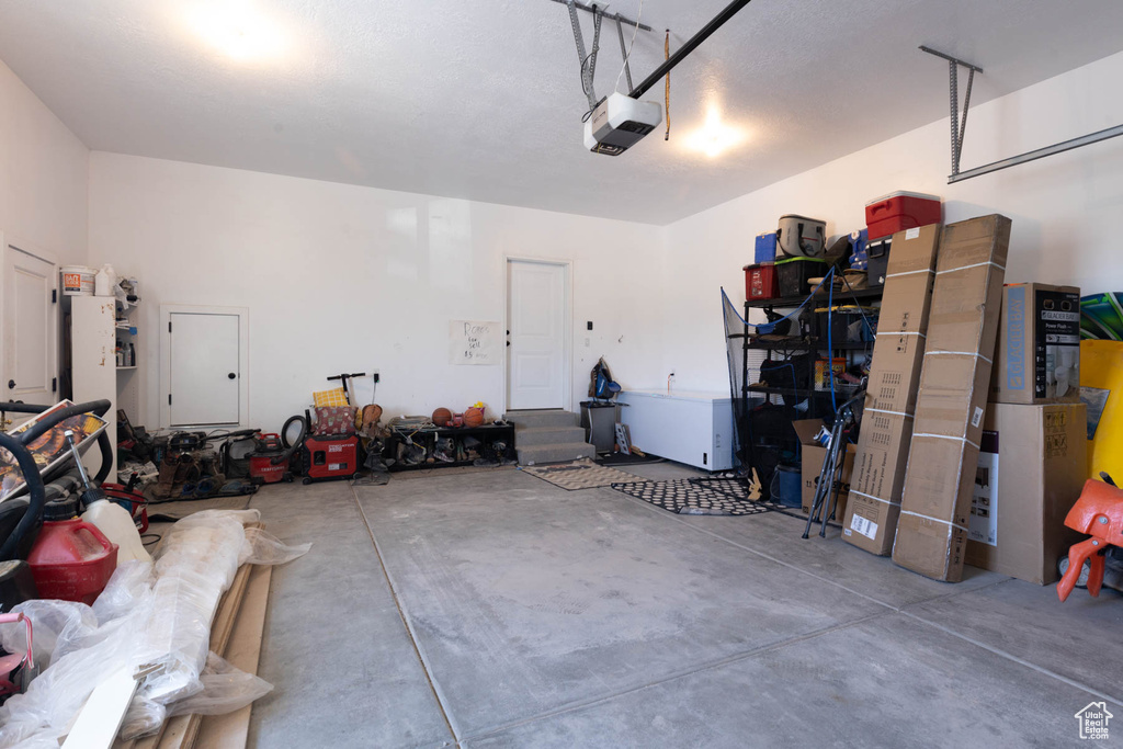 Garage featuring a garage door opener