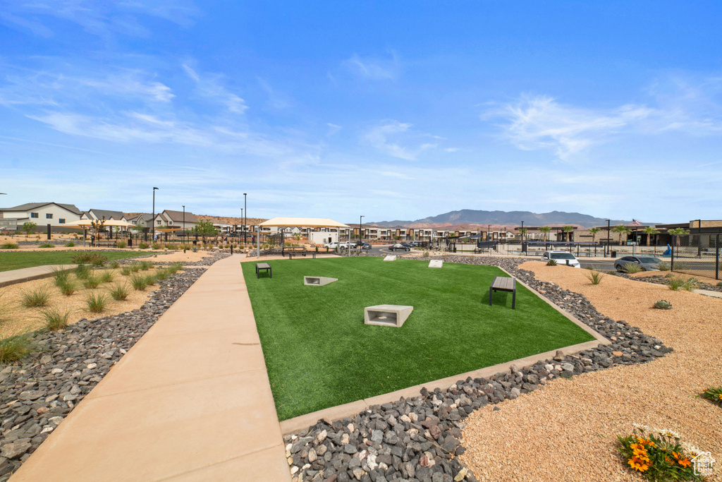 View of property's community with a yard, a residential view, and a mountain view