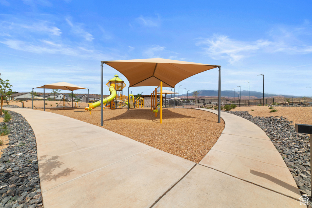 Communal playground with fence and a mountain view