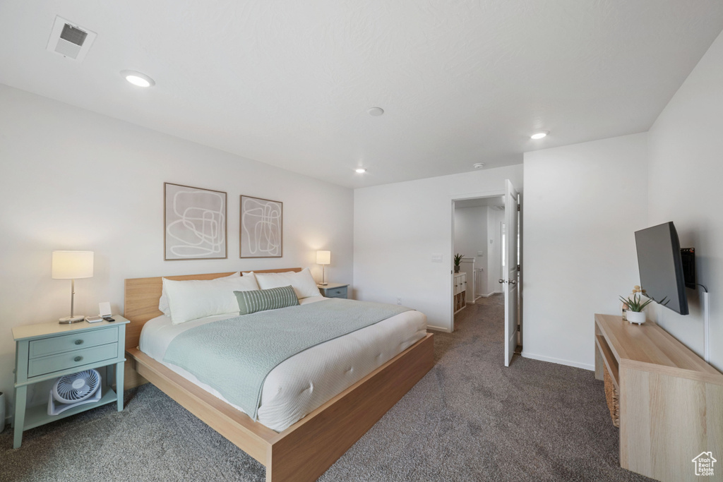 Carpeted bedroom with recessed lighting, baseboards, and visible vents