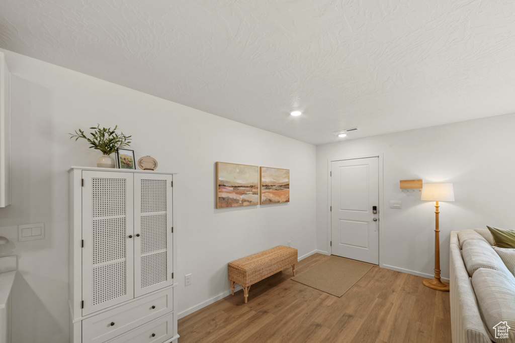 Entryway featuring baseboards, recessed lighting, and light wood finished floors