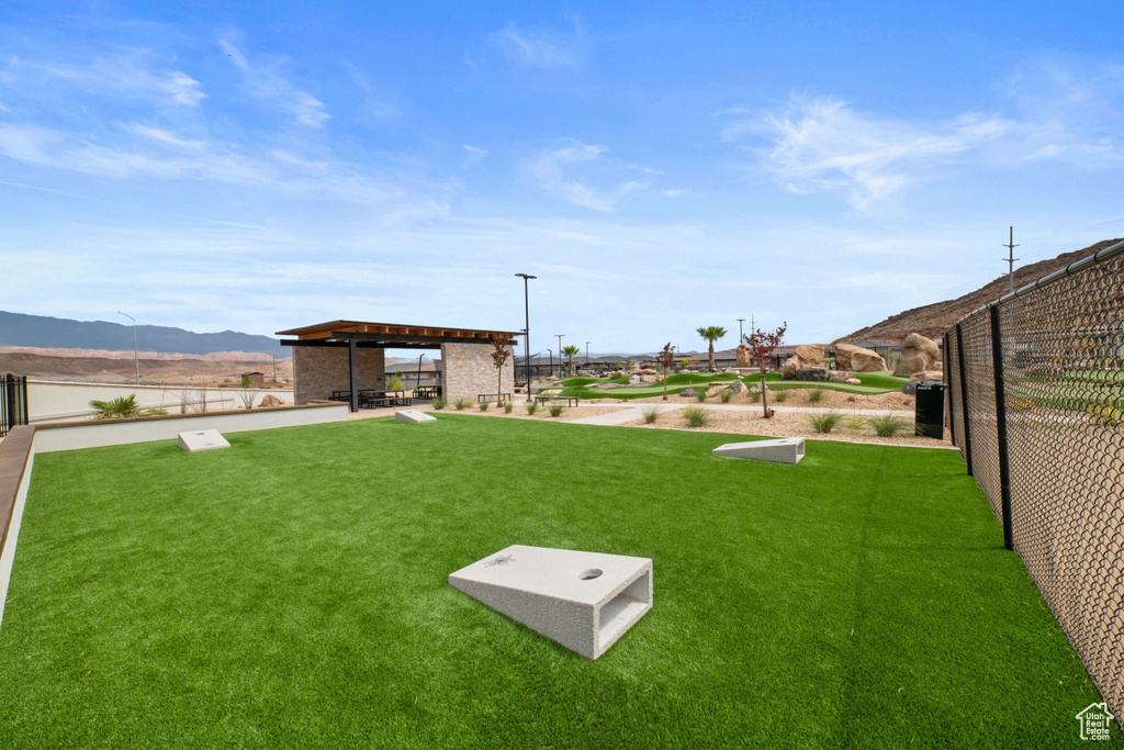 View of yard featuring fence, a mountain view, and a gazebo