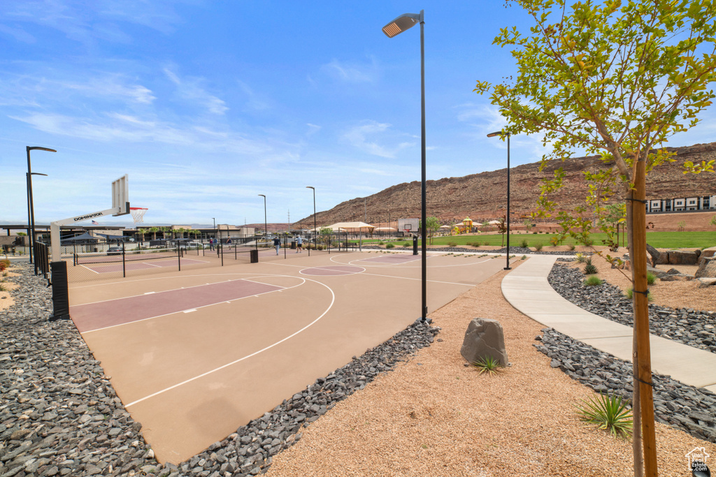 View of sport court with a mountain view, community basketball court, and fence