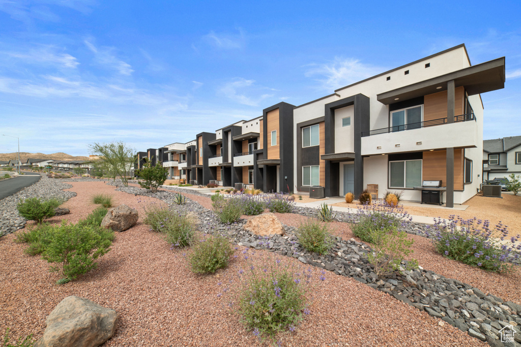 View of building exterior featuring a residential view and central AC