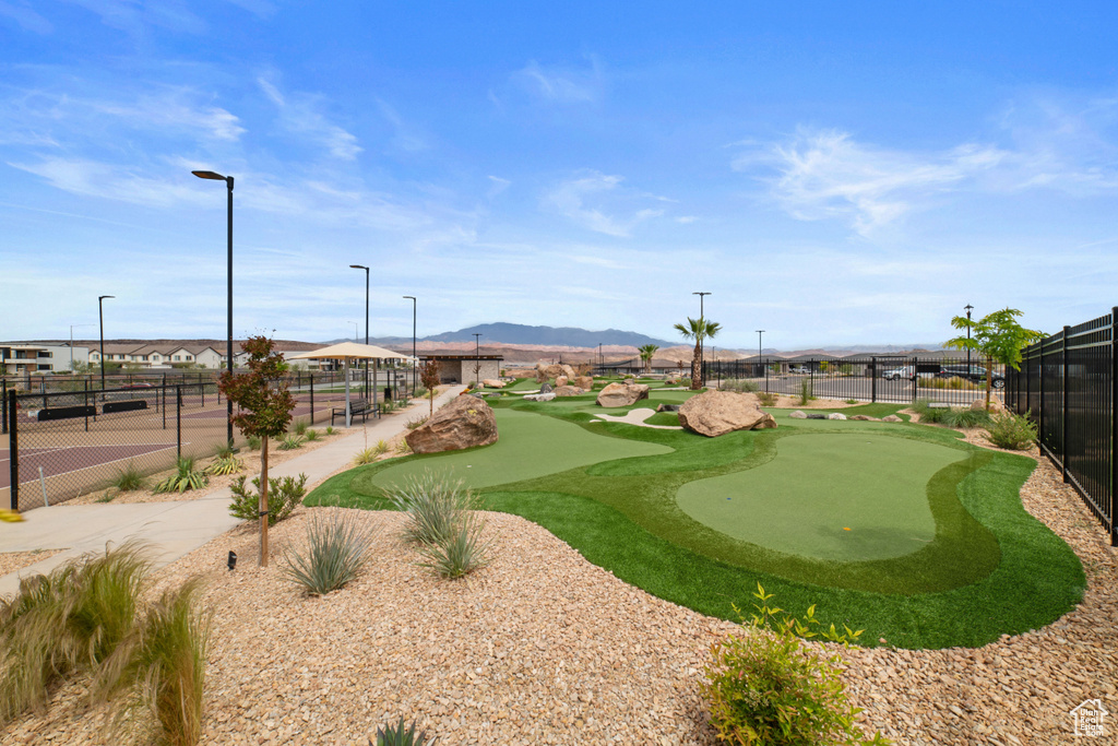 View of home's community featuring fence, a mountain view, and golf course view