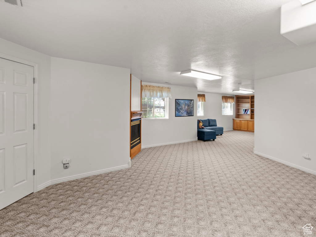 Basement featuring carpet floors and baseboards