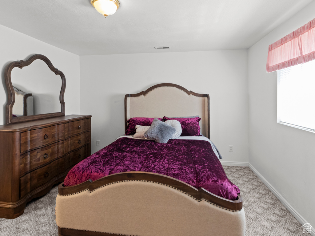 Bedroom featuring carpet floors, baseboards, and visible vents