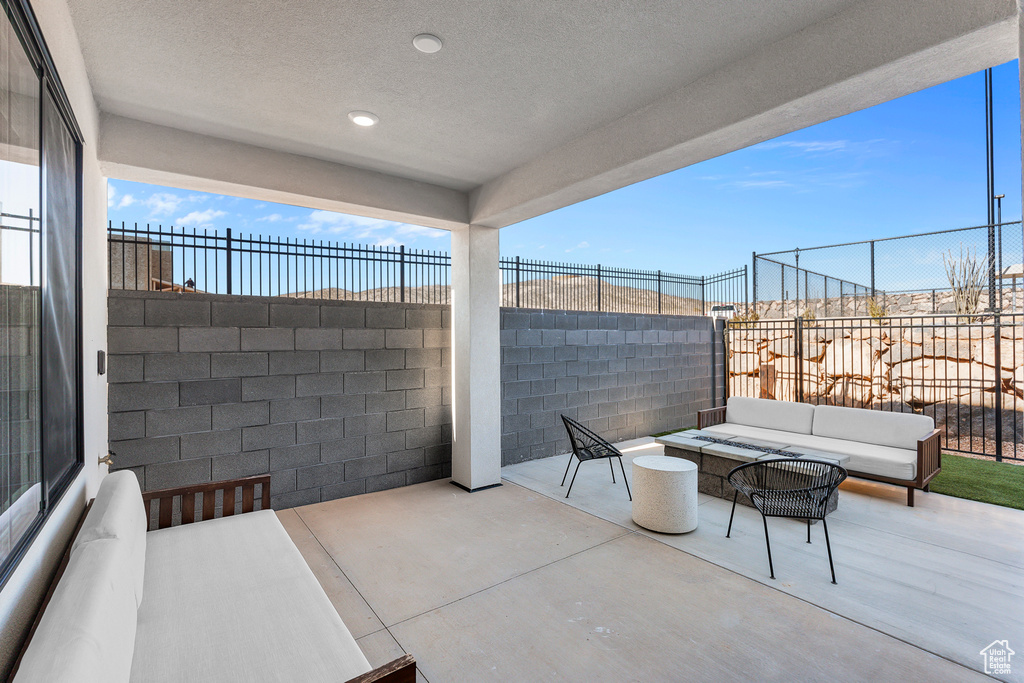 View of patio featuring fence and an outdoor living space
