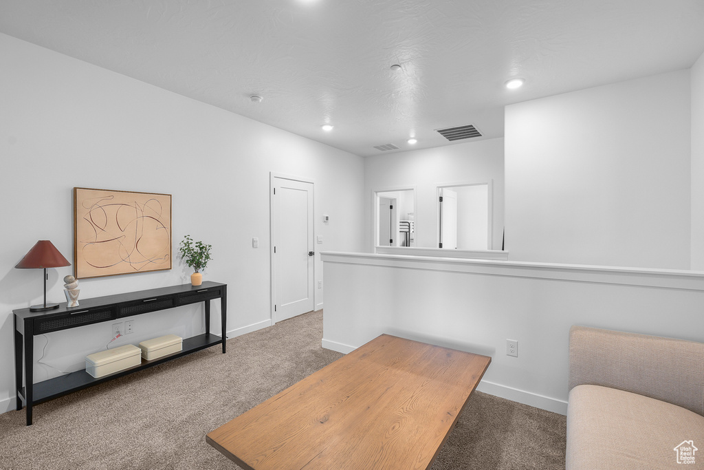 Office with baseboards, visible vents, and carpet