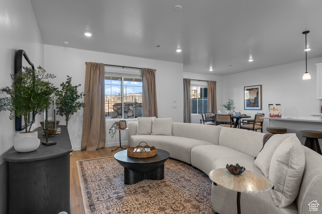 Living area with recessed lighting, baseboards, and wood finished floors