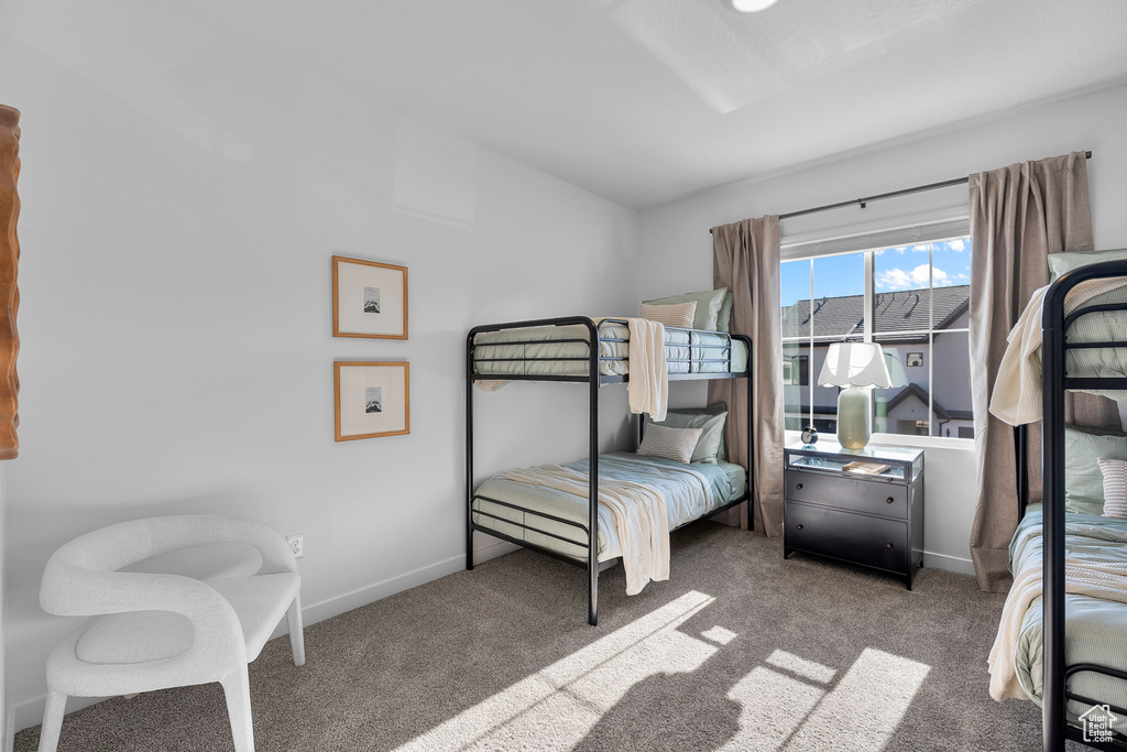 Bedroom featuring carpet floors and baseboards