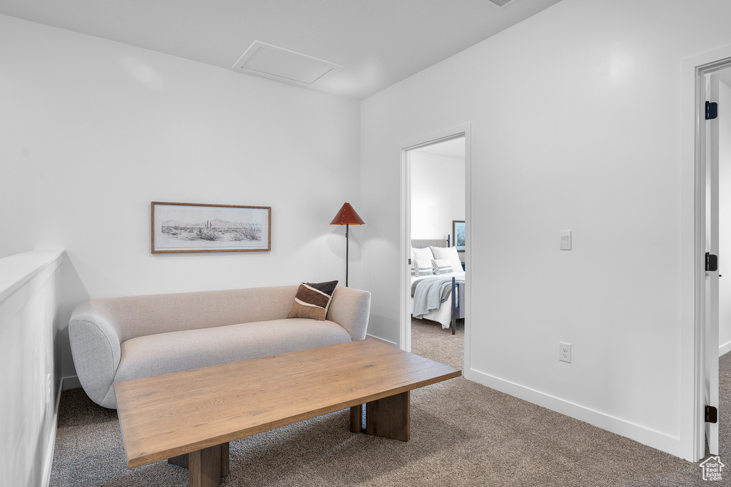 Sitting room with baseboards, carpet flooring, and attic access