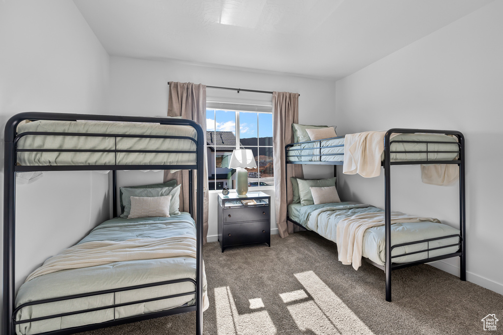Carpeted bedroom featuring baseboards