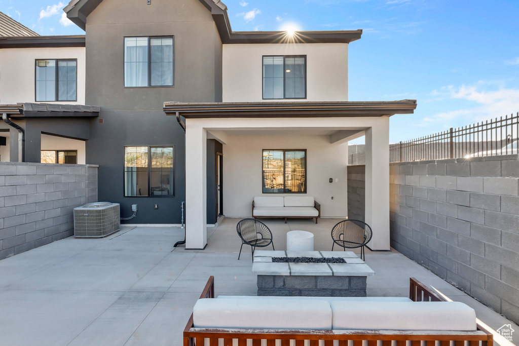 Back of property featuring a patio, central AC, fence private yard, and stucco siding