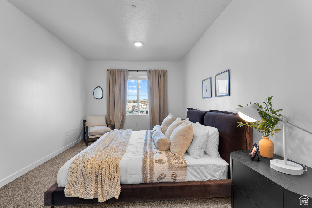 Carpeted bedroom featuring baseboards