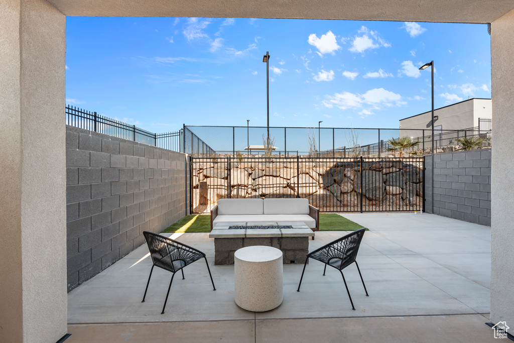 View of patio / terrace featuring a fenced backyard and an outdoor living space with a fire pit
