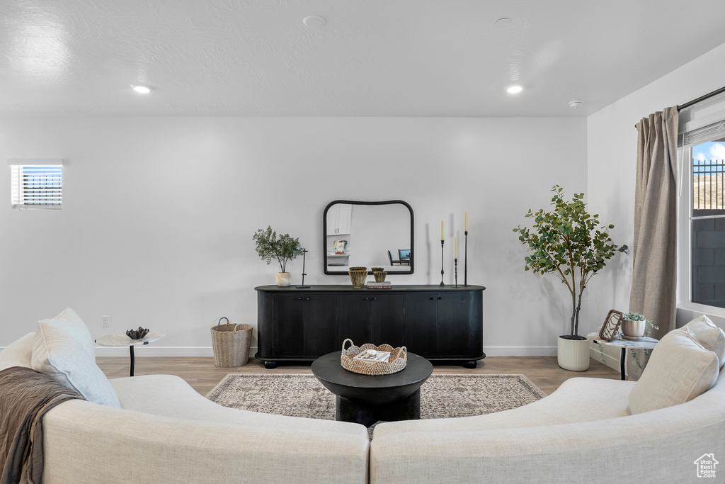 Living room featuring baseboards, recessed lighting, and light wood-style floors