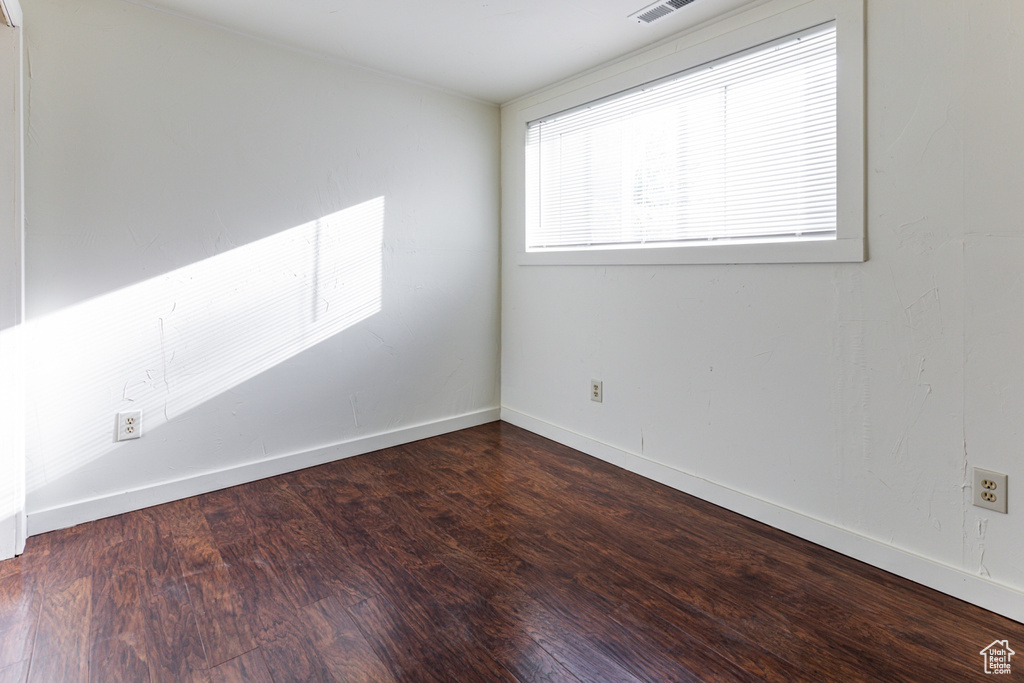 Empty room with baseboards and wood finished floors