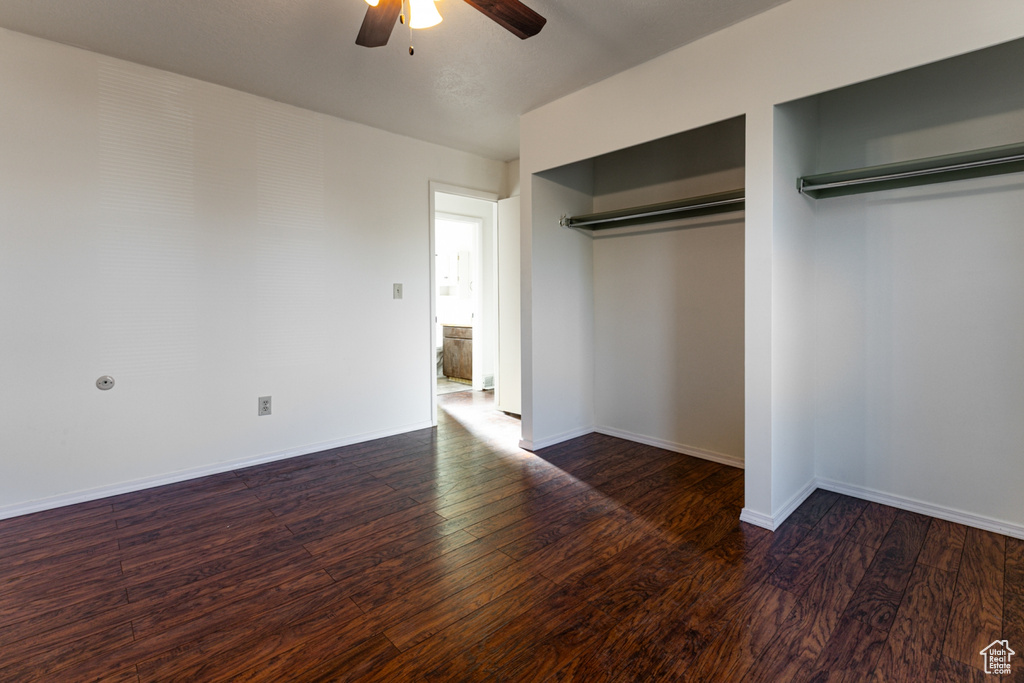Unfurnished bedroom with baseboards, ceiling fan, and wood finished floors