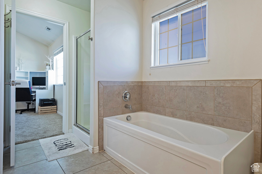 Bathroom with tile patterned floors, a shower stall, vaulted ceiling, visible vents, and a garden tub