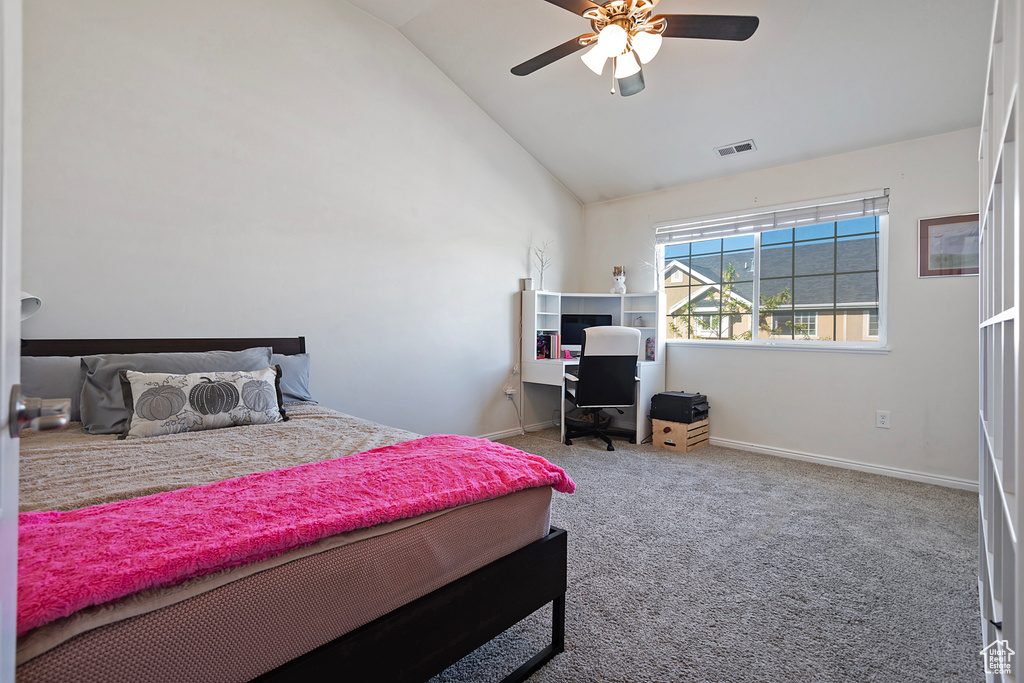 Carpeted bedroom featuring visible vents, a ceiling fan, baseboards, and high vaulted ceiling