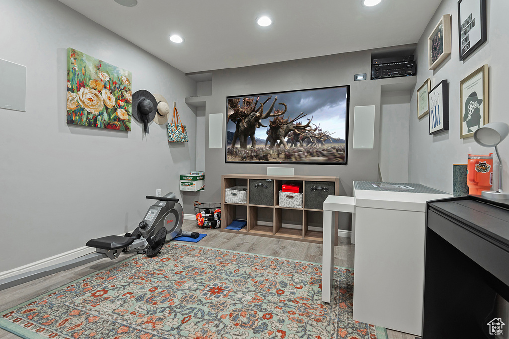 Interior space with baseboards, recessed lighting, and wood finished floors