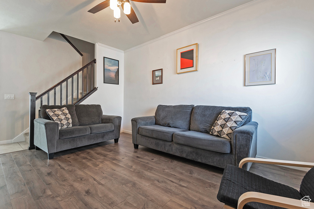 Living room featuring stairway, baseboards, a ceiling fan, and wood finished floors