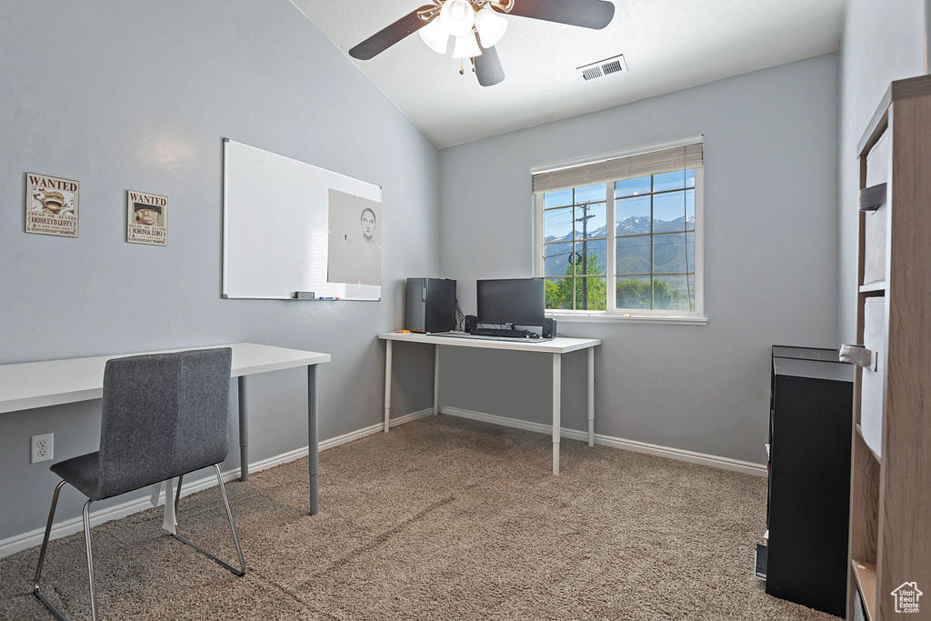 Carpeted office space with baseboards, a ceiling fan, lofted ceiling, and visible vents