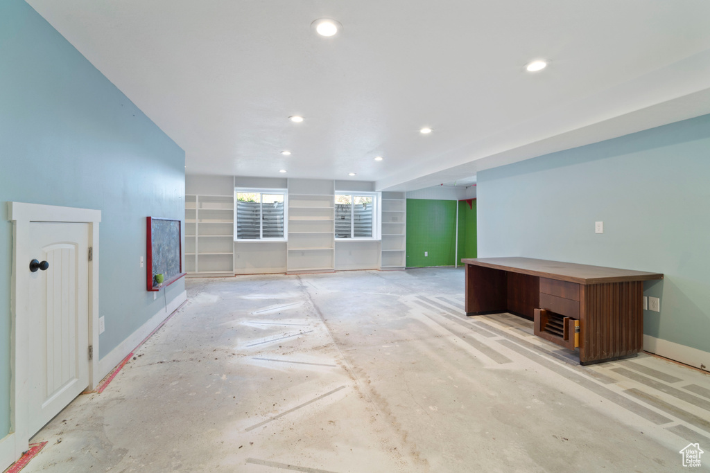 Basement with baseboards and recessed lighting