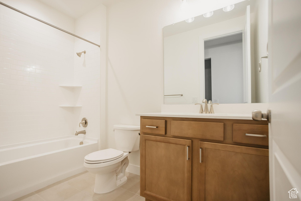 Full bath featuring tile patterned floors, vanity, toilet, and bathing tub / shower combination