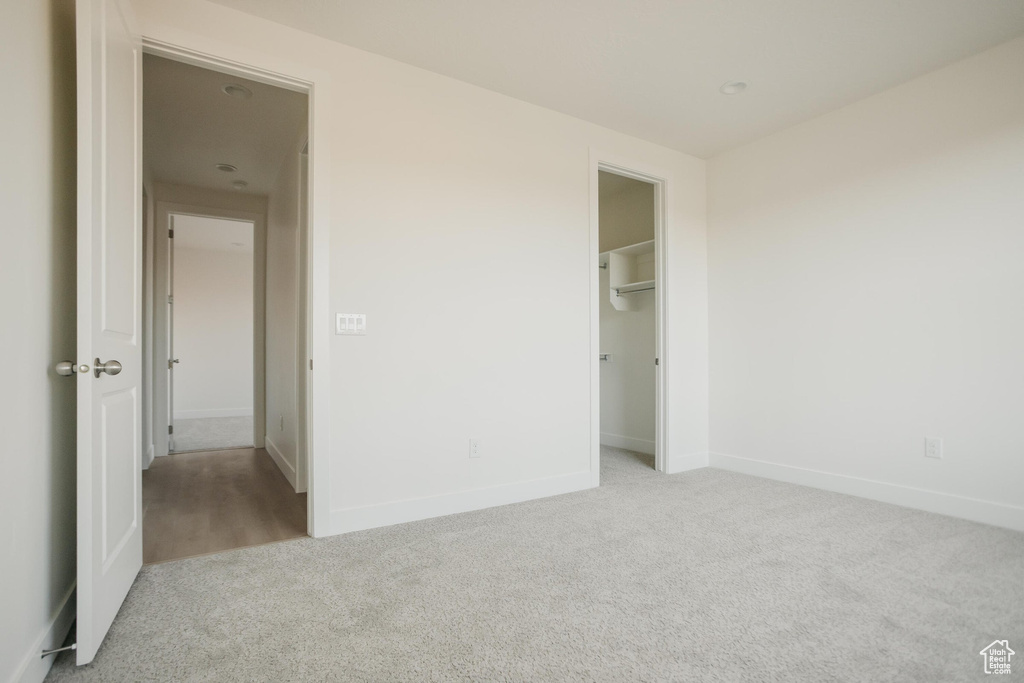 Unfurnished bedroom featuring baseboards, carpet, and a closet