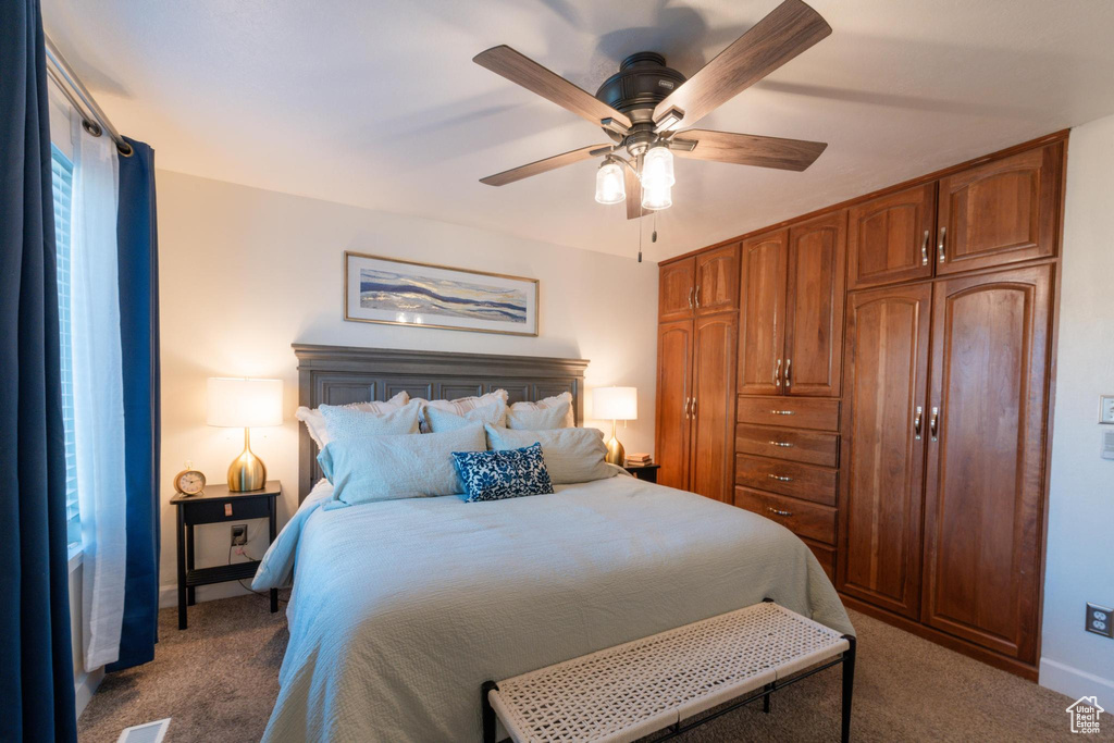 Bedroom with carpet floors, a ceiling fan, and baseboards