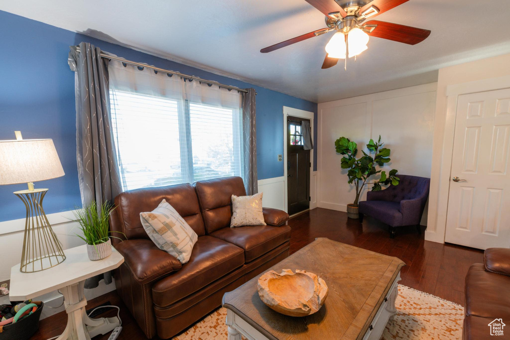 Living area featuring ceiling fan and wood finished floors
