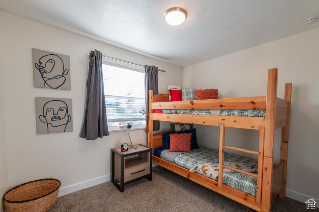 Carpeted bedroom featuring baseboards