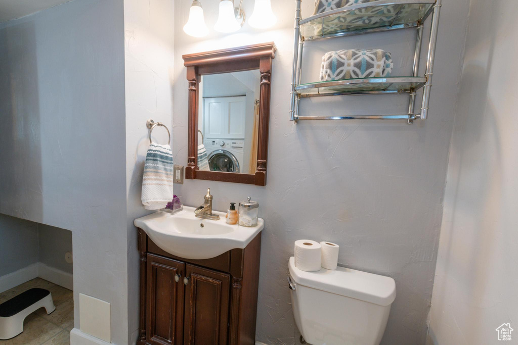 Bathroom with vanity, washer / clothes dryer, and toilet